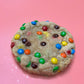 A sugar cookie dough filled to the brim with M&M candies.