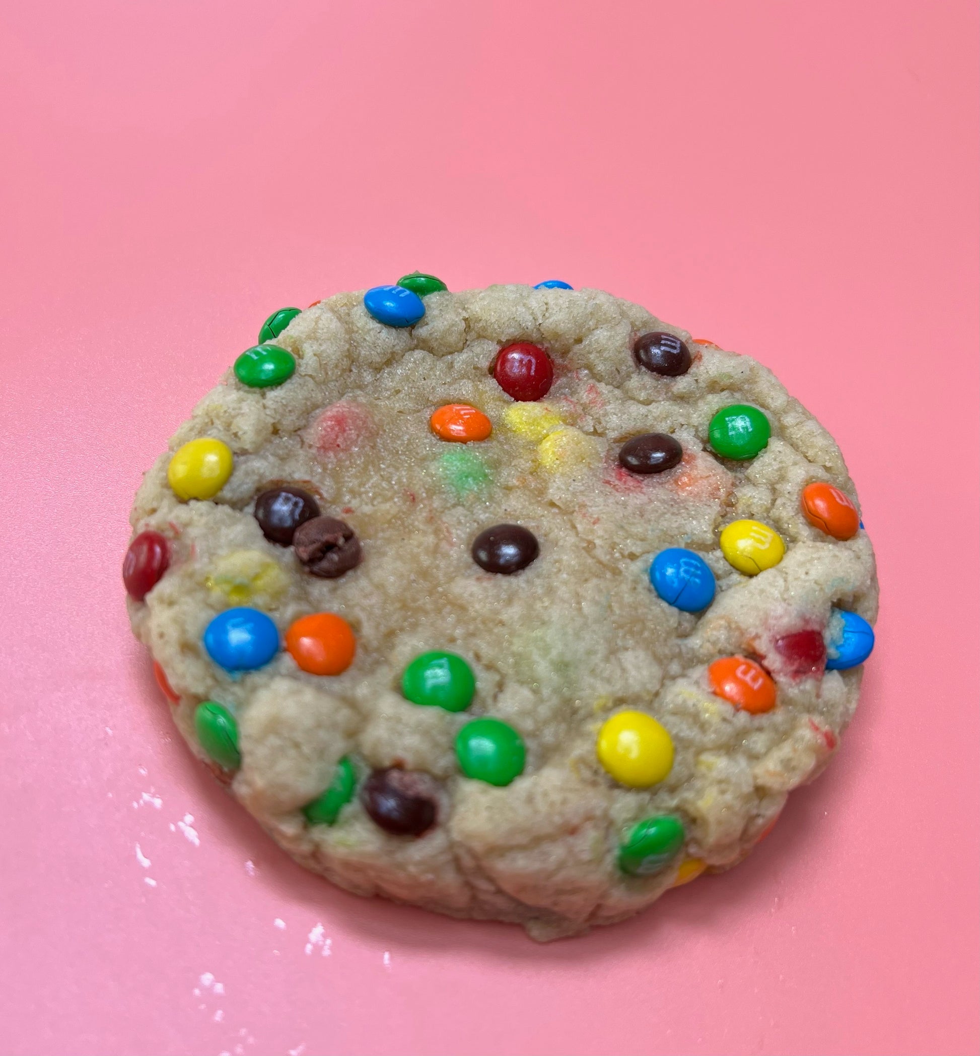 A sugar cookie dough filled to the brim with M&M candies.